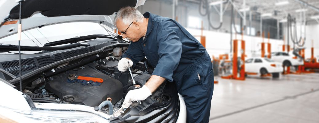 A mechanic fixing an engine