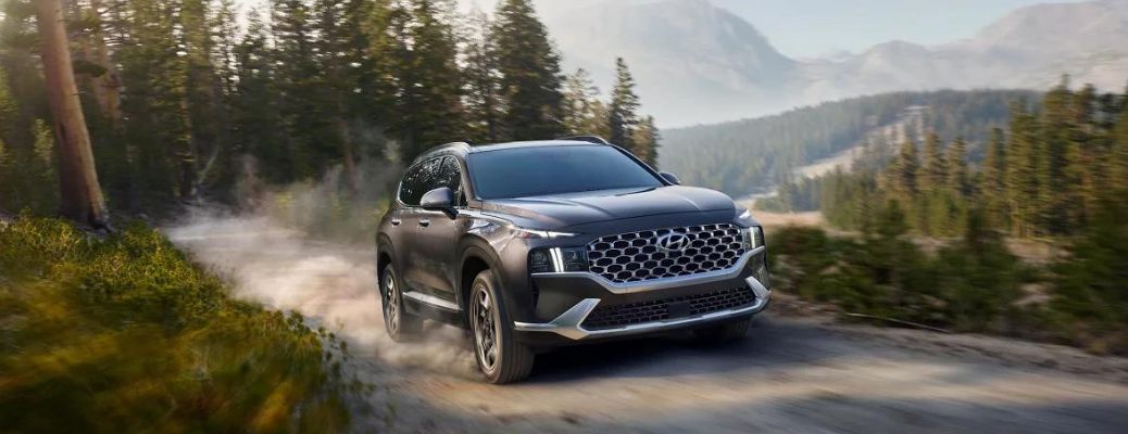 2023 Hyundai Santa FE Hybrid driving on a dusty road